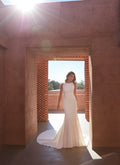Madison James-Blends modern minimalism with intricate detailing, featuring a high boat neckline