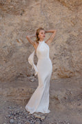 Victoria is a high-neck halter gown in liquid satin that drapes with quiet luxury.