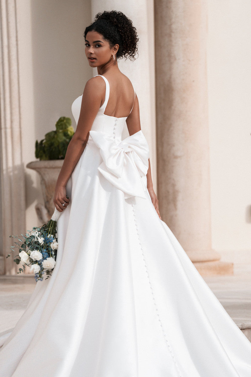 Mikado ballgown stuns with a classic scoop neckline and delicate spaghetti straps